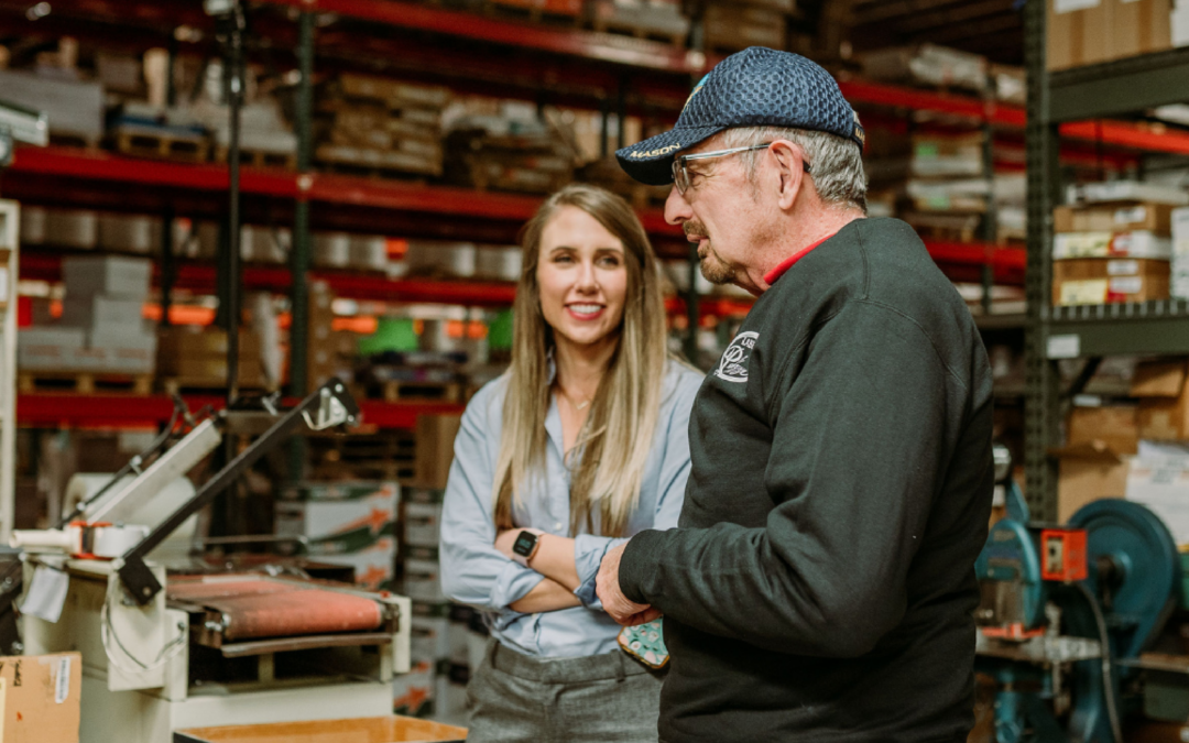 Man and woman talking about business in a warehouse