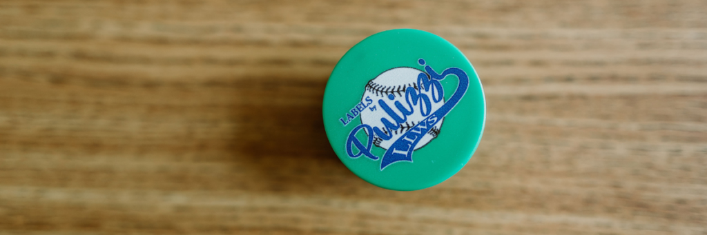 Green pop socket with Labels By Pulizza little league world series logo with a baseball behind the text