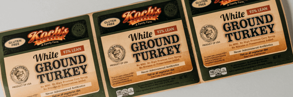 Close up photo of professional printed labels for Koch's white ground turkey with dark greens, tans, and black