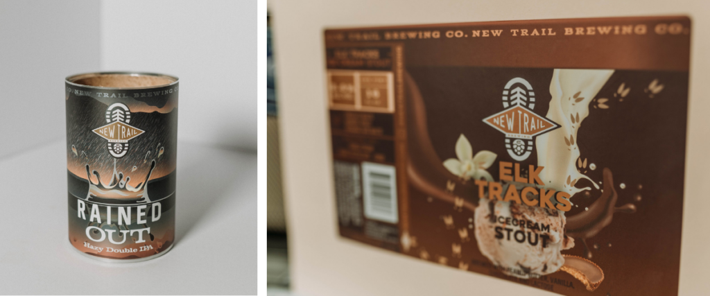 New Trail Brewing craft beer labels featuring Rained Out Hazy Double IPA and Elk Tracks Ice Cream Stout with illustrated artwork and bold brewery branding