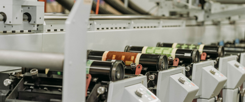Can labeling machine applying custom New Trail Brewing beer labels during brewery production process